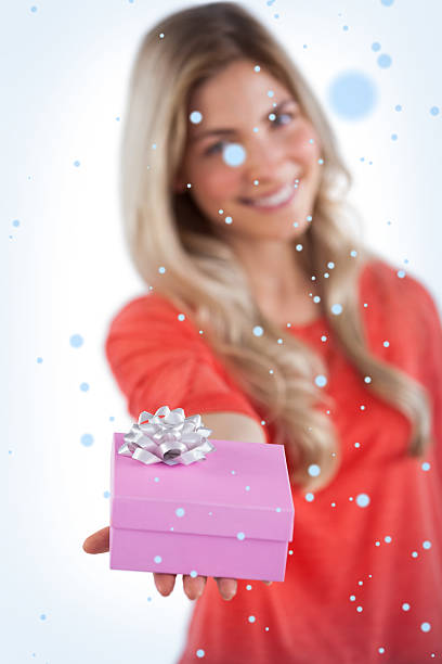 istock Composite image of young woman giving a gift 523923433