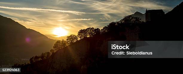 Silhouette Of Castle Tyrol On Rock Ridge At Sunset Stock Photo - Download Image Now