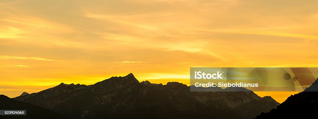 Sunset above the Vinschgau (South Tyrol) with mountain silhouette. Sunset above the Vinschgau (South Tyrol) with mountain silhouette. In the distance, the mountain peaks Trumsspitz and Grubenspitz are visible. Above Stock Photo