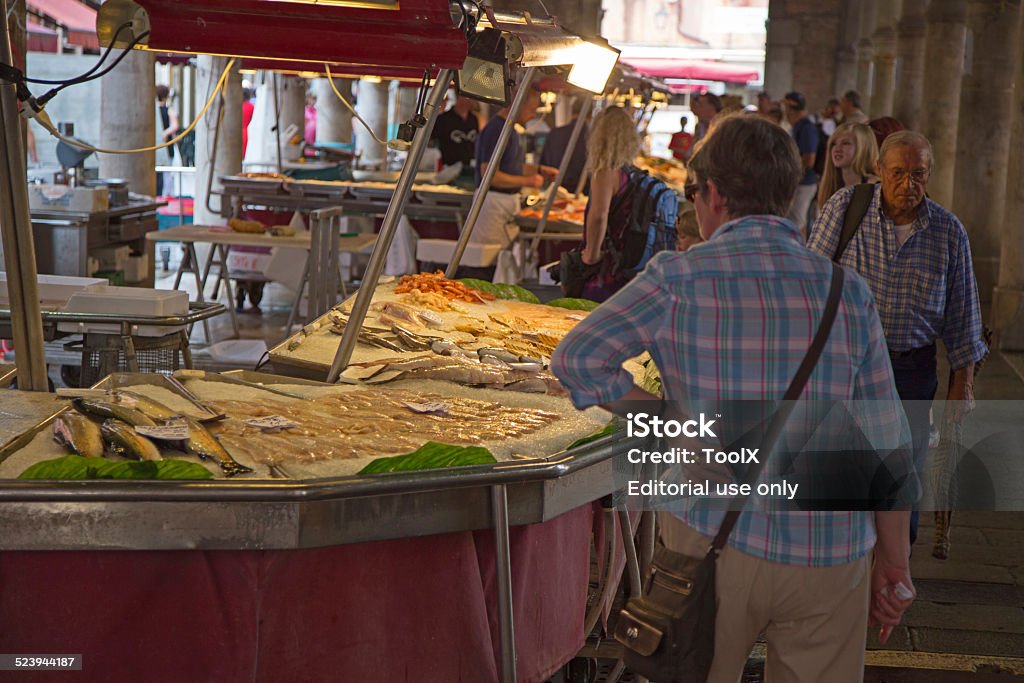 Fresh seafood market Venice, Italy - June 18, 2013: Shoppers  at seafood market in Venice Buying Stock Photo