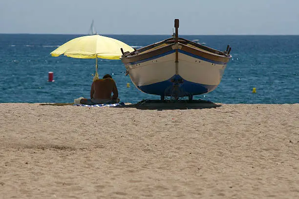 Man next to boat on the beach