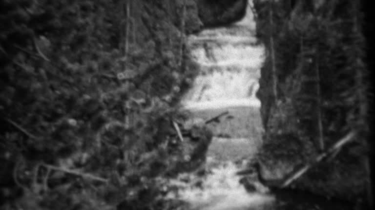 1937: Kepler Cascades waterfall high running fast tilt down follow river.