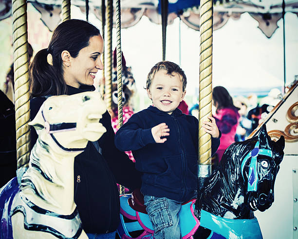 istock Boy Waving on a Carousel Ride with Mother - Retro 523965613
