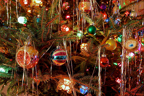 Kitsch 70s style decorated Christmas Tree Close up of Christmas Tree decorated with antique glass baubles and coloured lights in kitsch retro 70s style tinsel stock pictures, royalty-free photos & images