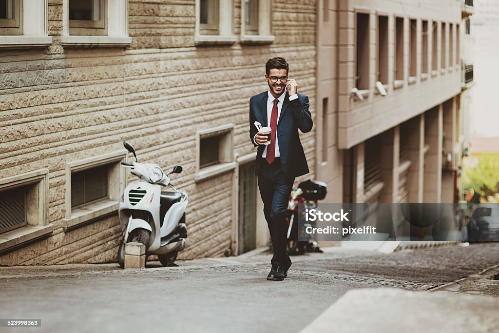 Businessman walking on the street with phone Shot made during Istockalypse Istanbul 2014 event. 25-29 Years Stock Photo