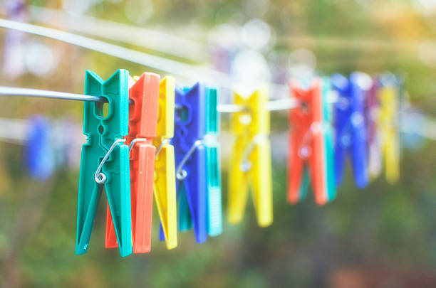 Clothes clamps in sunshine. Selective focus. Warm light with film look.
