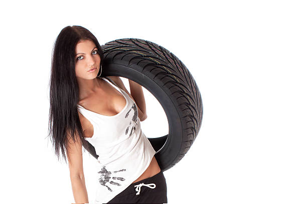 istock Tire. Girl holding a car wheel 524006254