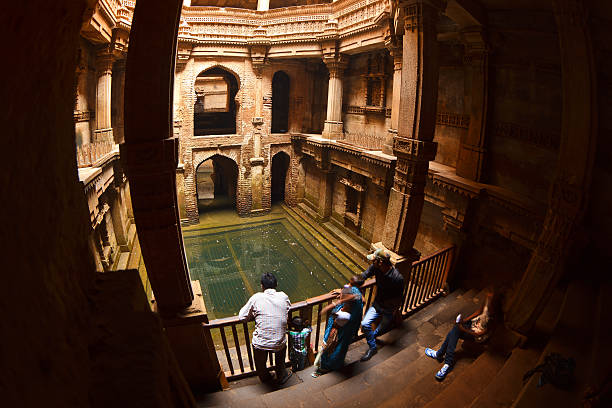 Adalaj Ki Vav Ahmedabad, India - January 16, 2016: Visitors admire the beauty of architecture and carved walls of Adalaj Ki Vav - famous traditional stepwell gujarat stock pictures, royalty-free photos & images