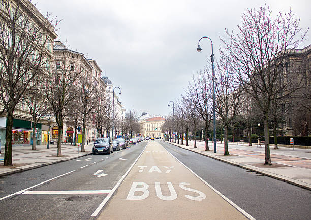 One street of Vienna in Austria. Horizontal composition. Outdoor shot. Image developed from RAW format. There is no traffic. Road is empty. There are only parked cars in left side of road.