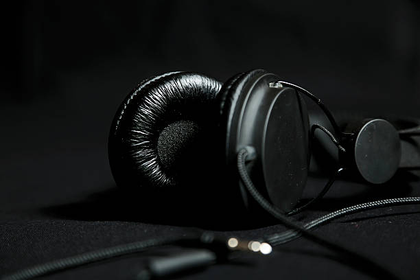 istock Black headphones on a black background 524009544