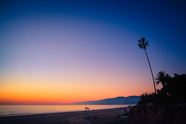 Santa Monica Bay & Mountains, From Palisades Park Bluffs Santa Monica Bay & Mountains as the glow of twilight recedes, as seen from the Palisades Park coastal bluffs in Santa Monica. fan palm tree photos stock pictures, royalty-free photos & images