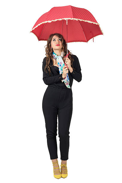 istock Cute woman with scarf under umbrella expecting rain looking up 524010258