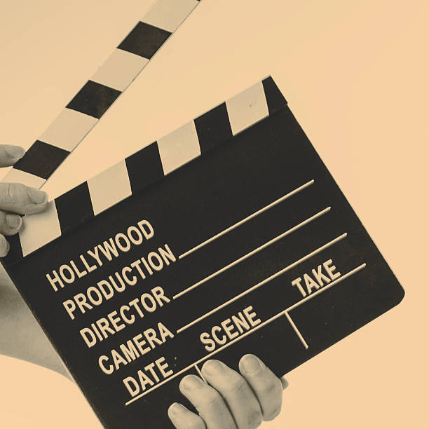 istock Movie flapper in woman´s hands on white background 524010292
