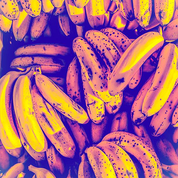 trendy multicolored background of bruised bananas.