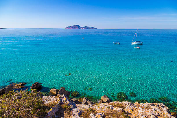 istock Azure lagoon called Cala Rossa with yachts moored 524013788