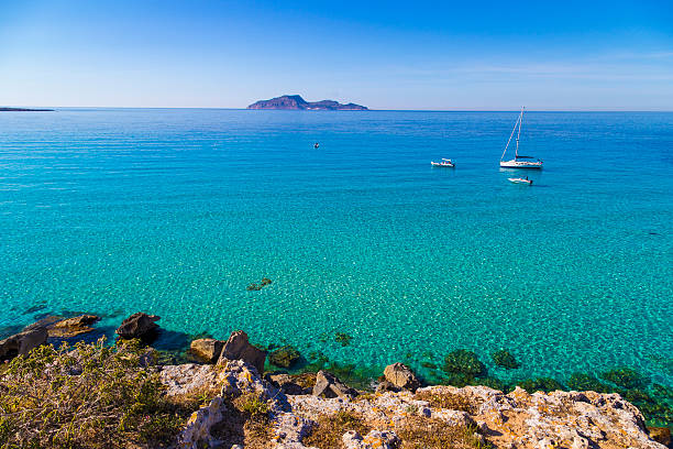 Azure lagoon called Cala Rossa with yachts moored Azure lagoon called Cala Rossa with yachts moored on Favignana island in Sicily, Italy favignana photos stock pictures, royalty-free photos & images