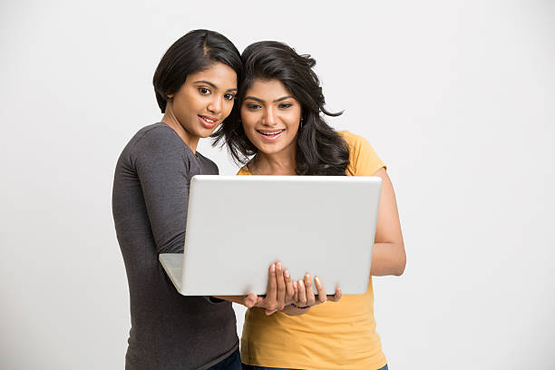 istock Two friends looking at laptop and discuss something 524014504