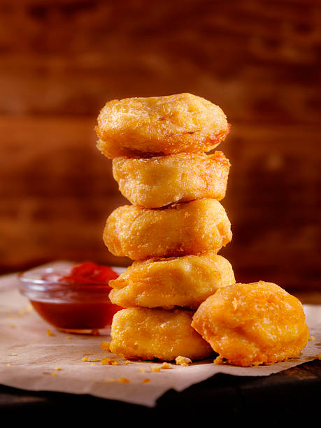 Chicken Nuggets with BBQ Sauce Dip Chicken Nuggets with BBQ Sauce Dip - Photographed on Hasselblad H3D2-39mb Camera nuggets heat stock pictures, royalty-free photos & images