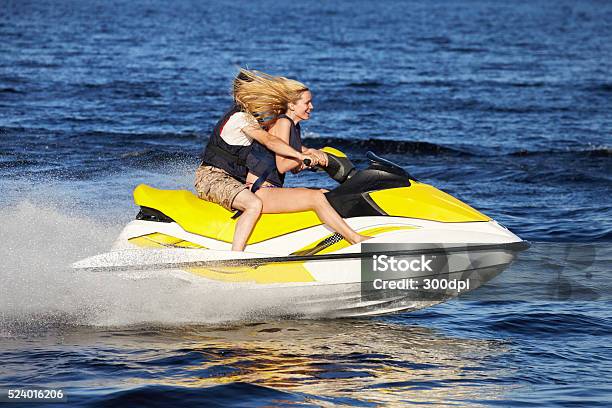 Couple Riding Jet Ski Stock Photo - Download Image Now - Personal Watercraft, Lake, Women
