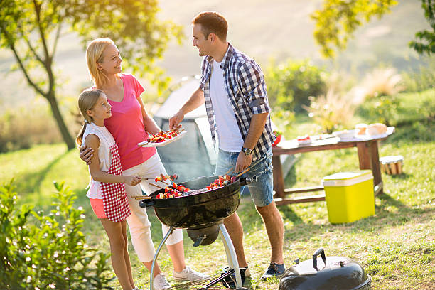 istock Happy parents grilling meat with daughter 524019286