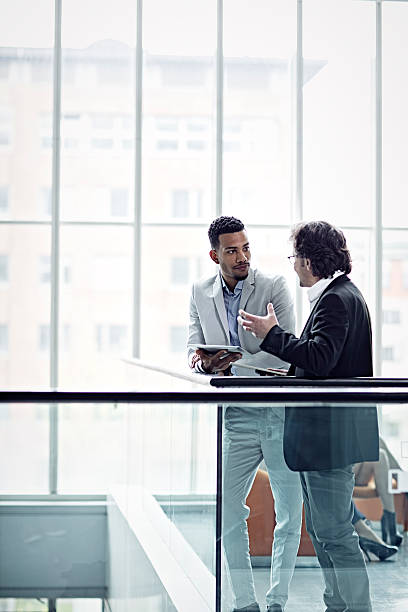 istock Two busuinessmen having a casual talk in hall 524021744