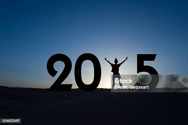 2015 Silhouette Of A Woman Standing In The Sunrise Stock Photo - Download Image Now
