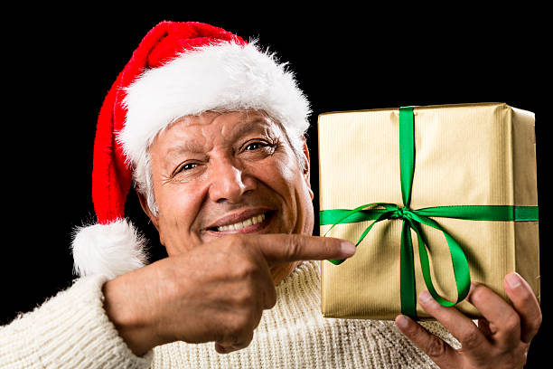 istock Broadly Grinning Aged Male Pointing At Golden Gift 524024311