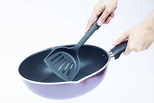 istock Hand with non stick frying pan on white background 524024742