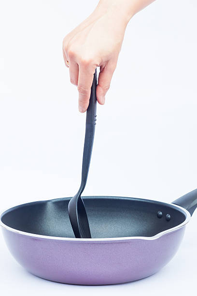 istock Hand with non stick frying pan on white background 524024764