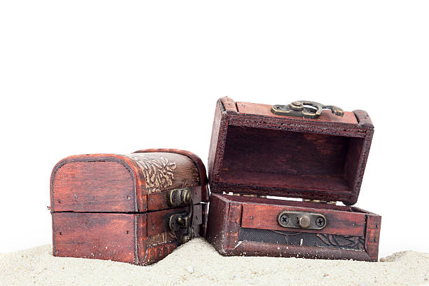 istock treasure box with sand isolated on white background. 524024894