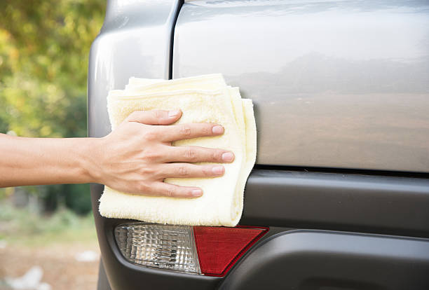 istock Cleaning car with microfiber yellow cloth 524025010