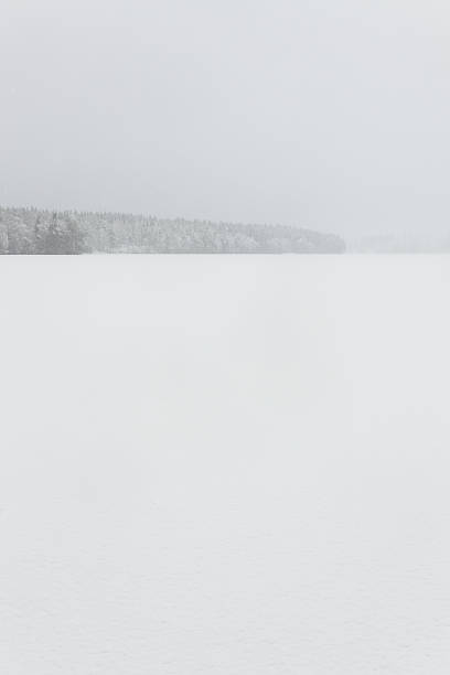 Blizzard winter landscape at frozen lake