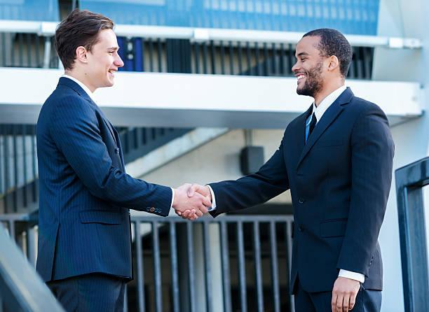 istock New partners. Two confident businessman shaking hands with each 524026105