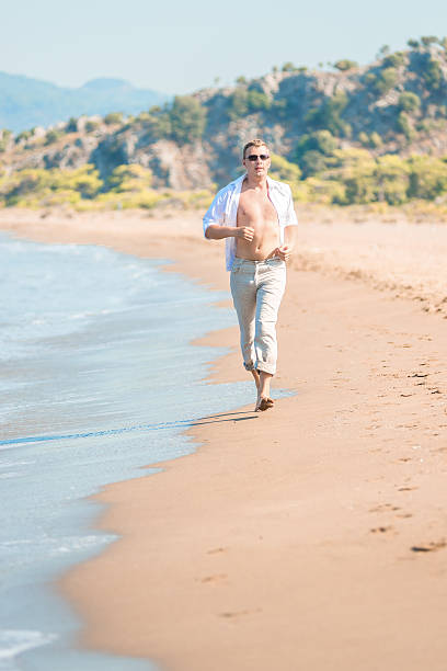 istock Vertical shot of the running men on the shore 524026657