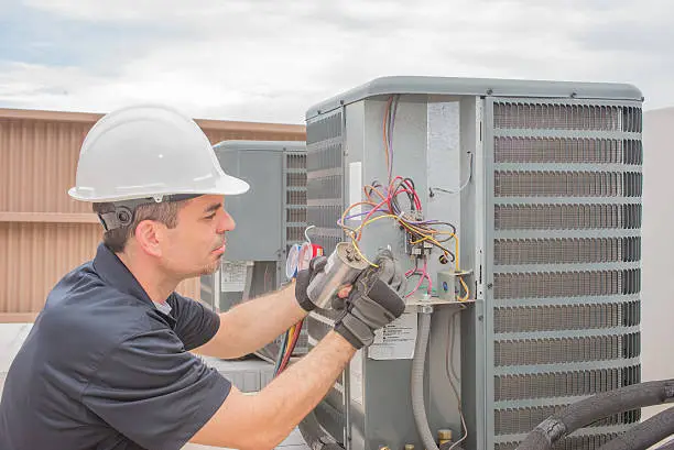 Photo of Technician and Capacitor