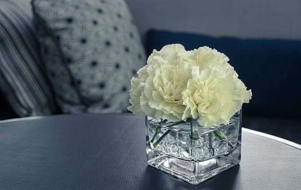 istock Pink carnation flower in a glass vase on table 524028086