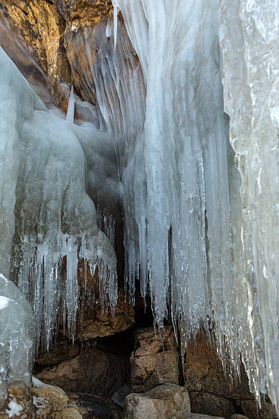 istock Grottoes and cracks in the rock with icicles 524028428