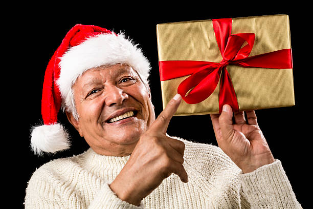 istock Avid Aged Man Pointing At Golden Wrapped Present 524028949