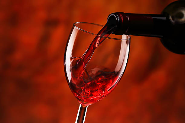 Pouring red wine stock photo