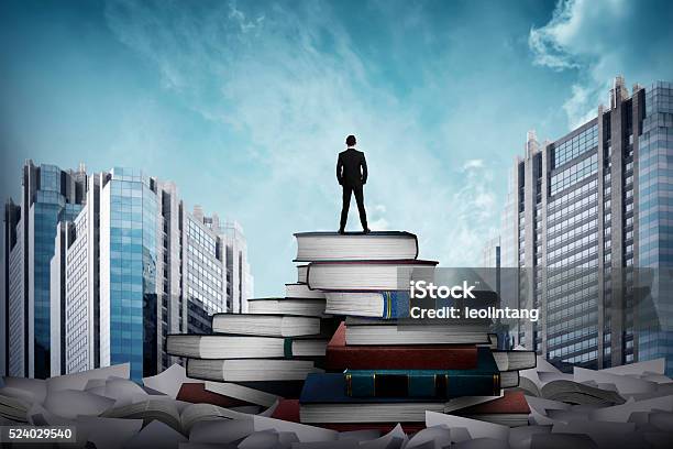 Business Man Standing On The Top Of Books Stock Photo - Download Image Now - Large, Library, Book