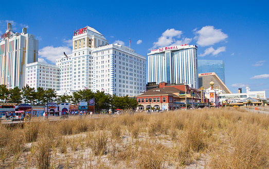 Atlantic City, NJ USA - April 27, 2014: Atlantic City New Jersey Casinos and Hotel from across the Broadwalk during a rough economic season with many closings and job losses as tourists stroll the seaside attractions.