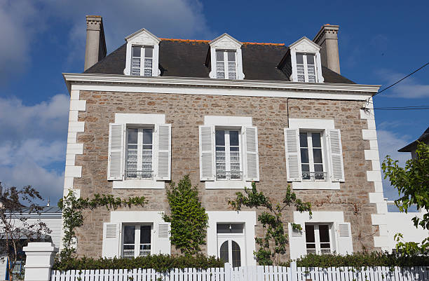 Old painted blue door and window on trendy coral color concrete wall. Banner with copy space. French village in Brittany.