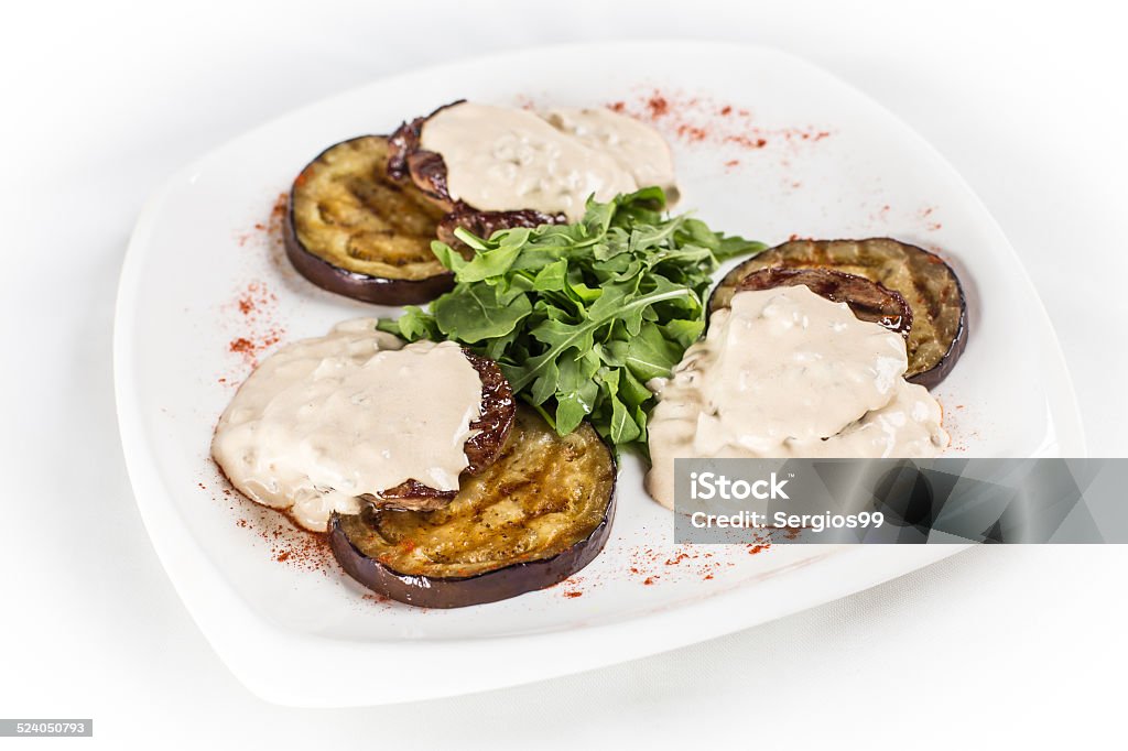 eggplant with arugula and sauce Eggplant, Vegetable, Baked, Zucchini, Food, Napkin, Tomato, Side View, Close-up, Horizontal, Portion, Green, Red, White, Ripe, Summer, Fork, Dishware, Plate, Dinner, Lunch, Tower, Decoration, Yellow, Freshness, Backgrounds, Chopped, Gourmet, Gratin, Vegetarian Food, Dieting, Healthy Eating, Arugula, Ratatouille, Appetizer, Grass, Snack, Decorating, Sauces, Dill, Squash, Marrow Squash, Cooked Appetizer Stock Photo