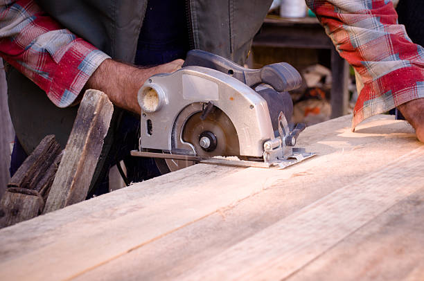 istock Man cutting wood with circular saw 524051253