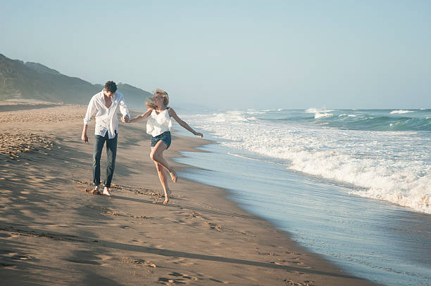 istock Young beautiful couple having fun at the beach 524052539