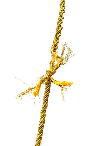 Torn golden rope stock photo