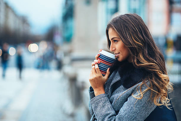 istock Young woman with coffee cup outdoors 524067251