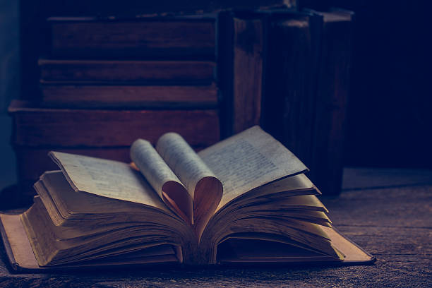 istock old book open on a wooden table 524068543