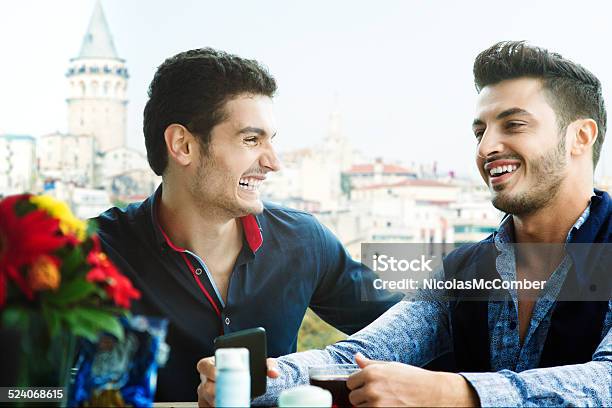 Two Male Friends Laughing In An Istanbul Cafe Stock Photo