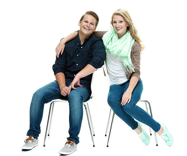istock Cheerful couple on chair looking at camera 524069031